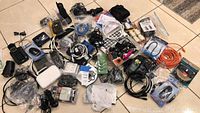 Wide view of assorted household electronics and cables in bin