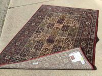 Ikea area rug 67x91 inches photographed partially rolled to show back label and detailed pattern on front