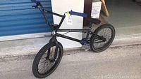 Full side view of black United Recruit BMX bike showing frame, wheels and pedals