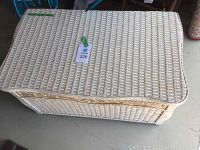 Top view of the rectangular wicker chest showing woven wicker pattern and tag with lot number 226.