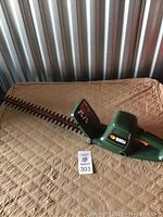 Full view of the Black and Decker electric hedge trimmer showing blade and handle.