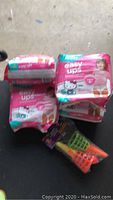 Two unopened packs of Huggies Easy Ups training pants and a kids' foam ball target toss game.