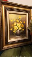 Framed original oil painting of yellow roses in a dark vase, signed by the artist.