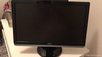 Front view of Dell monitor on a white surface showing the screen and Dell logo at the bottom bezel.