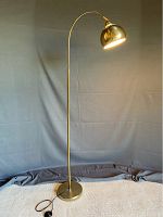 Full view of lamp showing arched stem, base, and shade