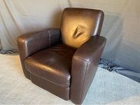 Front left three-quarter view of the chair showing seat cushion, armrest, and backrest