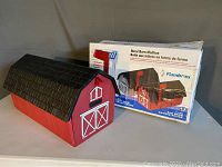 Flambeau Rural Barn Mailbox with original box in background showing product and text details