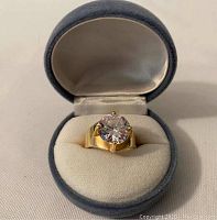 Ring displayed upright in padded jewelry box