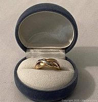 Gold ring with white gold accent in blue velvet box