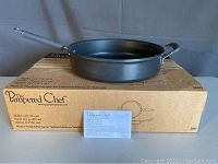 Pampered Chef skillet on top of original box with instruction card