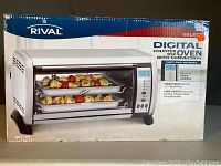 Front of sealed retail box showing Rival branding, product name and oven image
