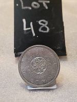 Reverse view of the 1964 Canada Silver Dollar coin showing floral emblem and inscriptions.
