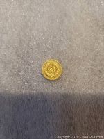 Gold coin front side with '1/4 CALIF GOLD 25CTS' inscribed with a wreath design