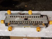 Top view of Craftsman deluxe dovetail jig showing adjustment knobs and dovetail slots.