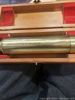 Brass telescope inside a wooden presentation box with red felt lining, engraved with 'THE RETURN OF HALLEY'S COMET 1985 - 1986' and a comet illustration.