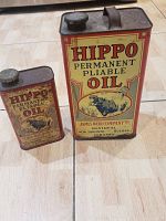 Front view of two Hippo Permanent Pliable Oil cans, small and large sizes.