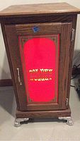 Front view of wooden stand with red illuminated panel reading GOLD NUGGET CASINO