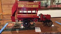 Front and side view of red double-decker Mamod steam bus model