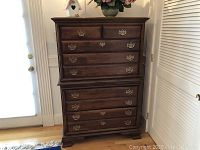 Full front view of two-piece highboy chest showing overall design and finish