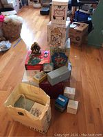 Stack of assorted boxes and bags containing music boxes and figurines