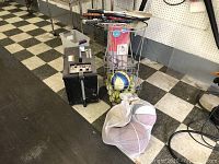 Overview of machine, ball basket, rackets and mesh bag of basketballs