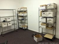 Three wire shelving units positioned in a corner, with boxes stored on shelves to show scale.