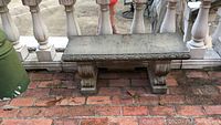 Bench with scroll-patterned top edge and brick patio