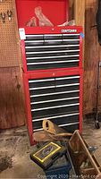 Front view of the two-piece red Craftsman tool chest with drawers and caster wheels
