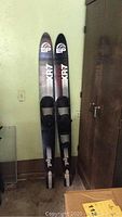 Full view of two EP XR7 water skis standing upright against a wall, showing overall length and design.