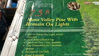 Close-up photo of the box detailing features of the Mesa Valley Pine Christmas tree including 7.5ft height, 400 pre-strung clear lights, 2146 natural branch tips, easy 2-step assembly, and indoor use only.
