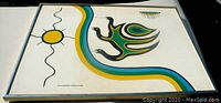Full view of the signed silkscreen print showing the design of Indigenous birds, sun, and wavy lines in vibrant colors within frame.