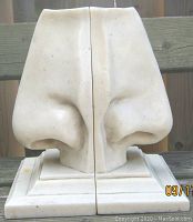 Front view of the two nose-shaped marble bookends placed side by side showing the detailed noses.