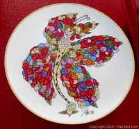 Front view of the 9-inch decorative plate showcasing colorful butterfly artwork by Toller Cranston with signature and gold rim.