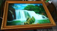 Front view of electric waterfall scene wall lamp with gold ornate frame showcasing the illuminated waterfall image.