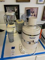 Photo showing the Jack LaLannes Power Juicer, Osterizer blender with two pitchers, and Black & Decker food processor together on table.