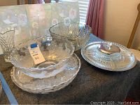 Photo showing the rose-themed glass serving bowl and platters alongside the silver vegetable tray and covered dip container on a table.
