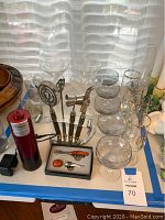 Full lot overview showing electric wine opener, bar tools on stand, stemware and glasses with gold ship decoration