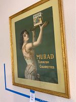 Framed vintage Murad Turkish Cigarettes poster showing a woman holding a tray with cigarette pack.