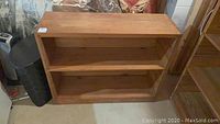 Full view of wooden bookcase showing overall structure and two fixed shelves.
