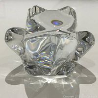 Top view of clear crystal frog figurine showing defined frog shape and reflections