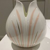 Front view of the white ceramic vase showing pink and gold linear impressions detail and split top opening.