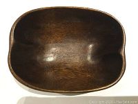 Top view of the mid-century teak wooden bowl showing the smooth interior and natural wood grain.