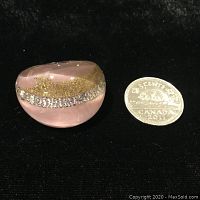 Front view of pink Murano glass ring next to Canadian five-cent coin for scale, showing embedded gold and silver flecks.