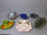 Wide view of all chip-and-dip bowls and centerpiece serving bowls shown together, displaying variety of colors, shapes, and sizes.