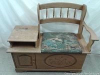 Full front view of the oak storage bench with tapestry seat and side table