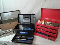 Overview of three tool boxes: black Park Tool box, green metal box, and red machinist chest with drawers, all containing tools.