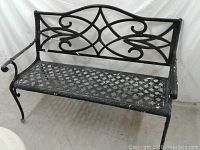 Front and side view of black metal park bench showing lattice seat and decorative swirls on backrest.