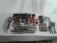 Overview of entire drill bit collection on table, bits, tins and boxes