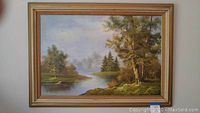 Full view of framed landscape oil painting showing lake, trees, canvas and frame