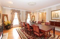 Formal dining room showing area rug in place under dining table with chairs, acting as reference for style and approximate sizing (8x10).